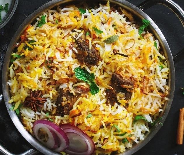 Biryani with basmati rice, tender meat, fried onion and whole spices at Masala Theory Calgary