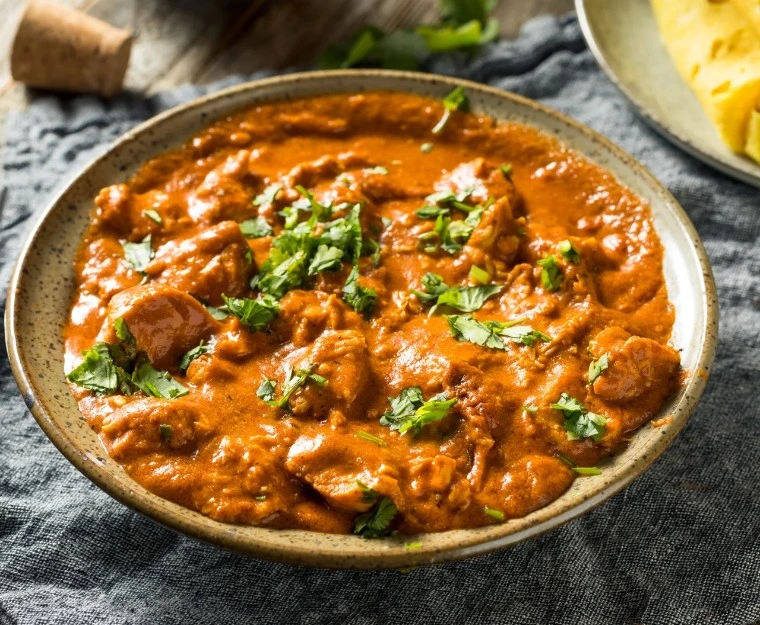 Butter Chicken curry topped with fresh coriander at Masala Theory Calgary SE