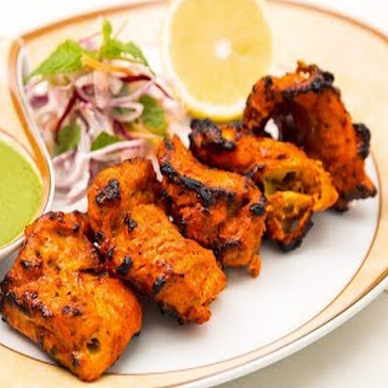 Tandoori Fish tikka with onion salad and mint chutney at Masala Theory Calgary